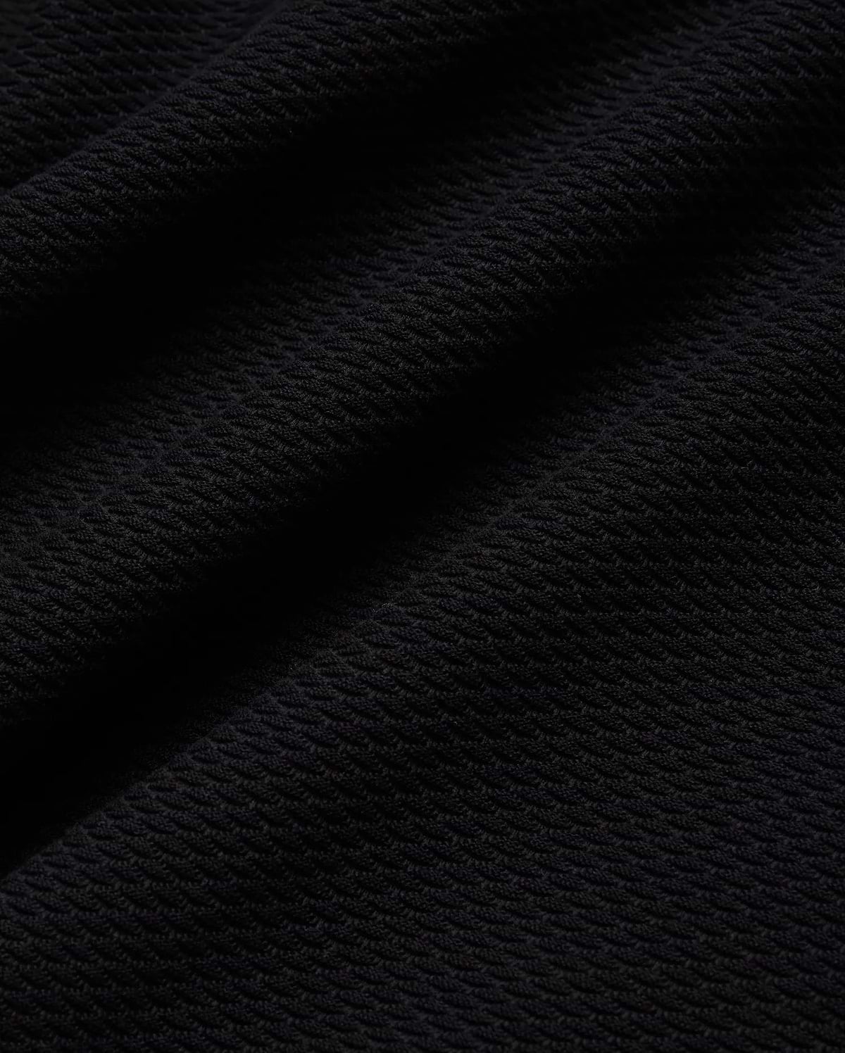 Mens Selby Knit Polo in deep black, showcasing a luxurious, finely textured knit fabric with a subtle, sophisticated diagonal pattern, ideal for refined streetwear. (5)