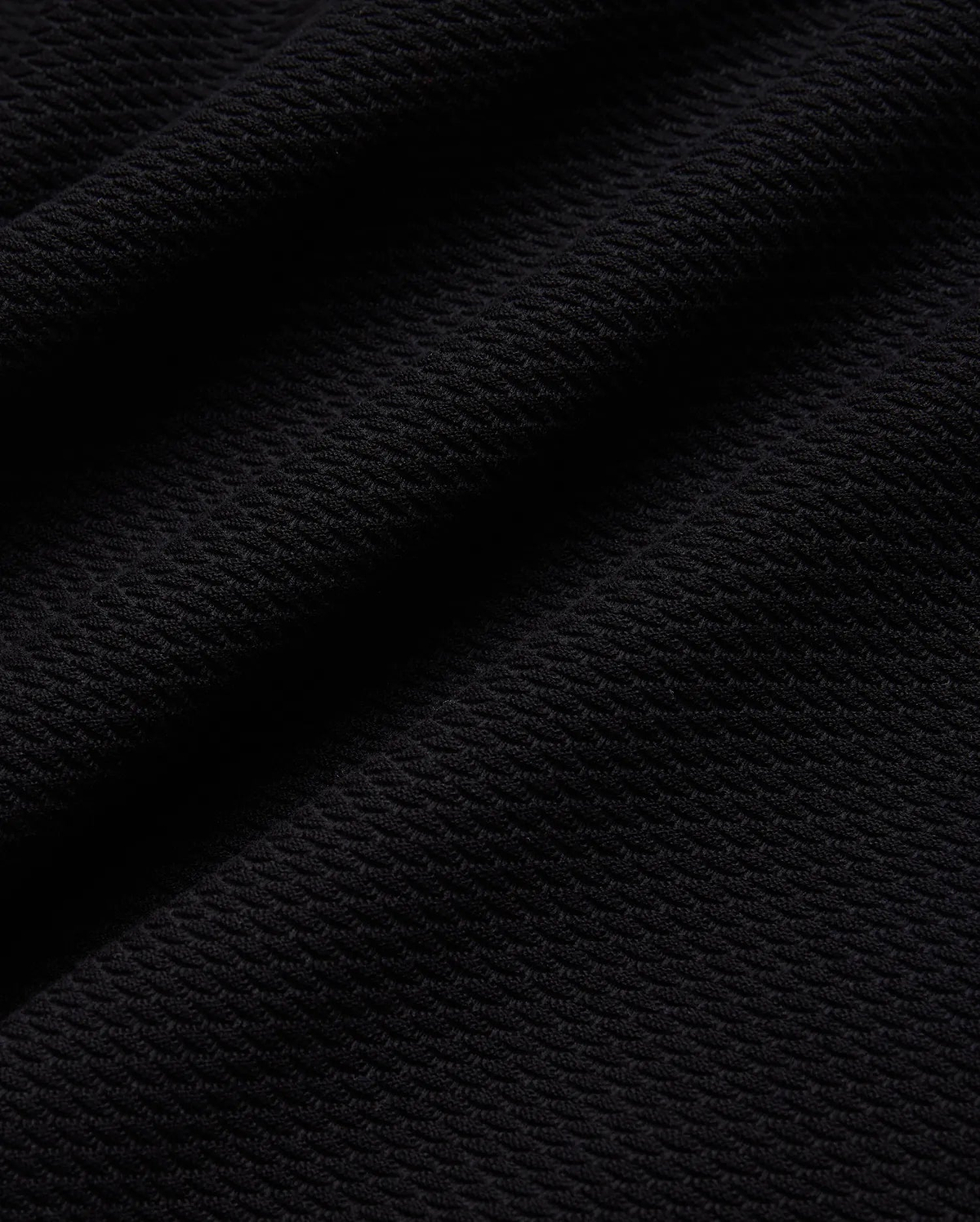 Mens Selby Knit Polo in deep black, showcasing a luxurious, finely textured knit fabric with a subtle, sophisticated diagonal pattern, ideal for refined streetwear. (5)
