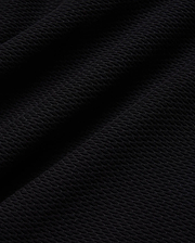 Mens Selby Knit Polo in deep black, showcasing a luxurious, finely textured knit fabric with a subtle, sophisticated diagonal pattern, ideal for refined streetwear. (5)