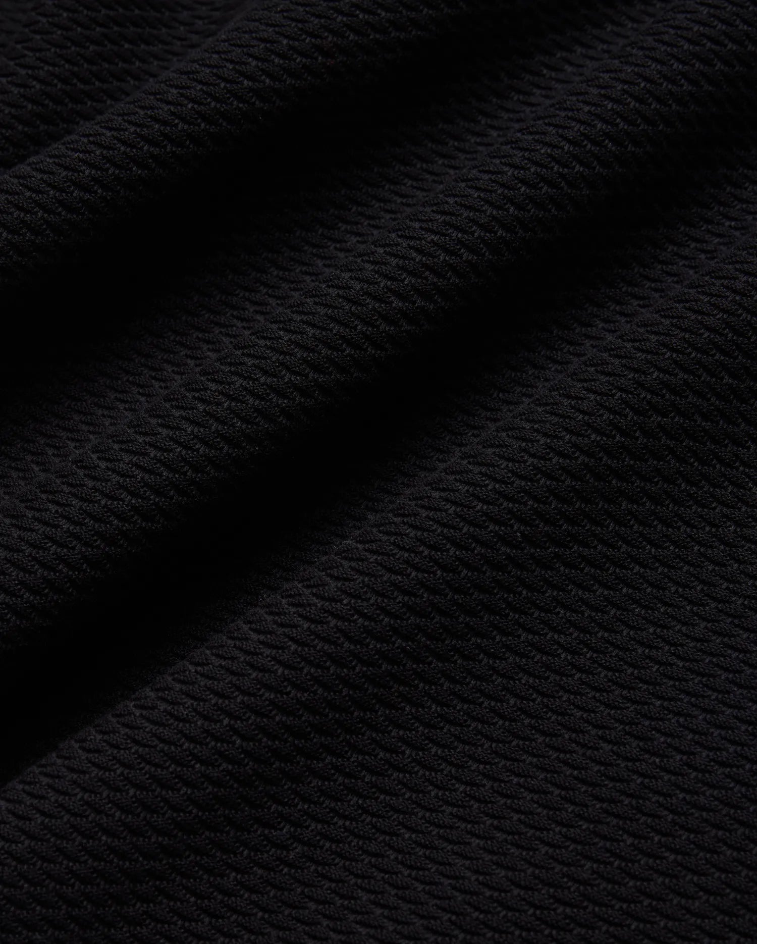 Mens Selby Knit Polo in deep black, showcasing a luxurious, finely textured knit fabric with a subtle, sophisticated diagonal pattern, ideal for refined streetwear. (5)