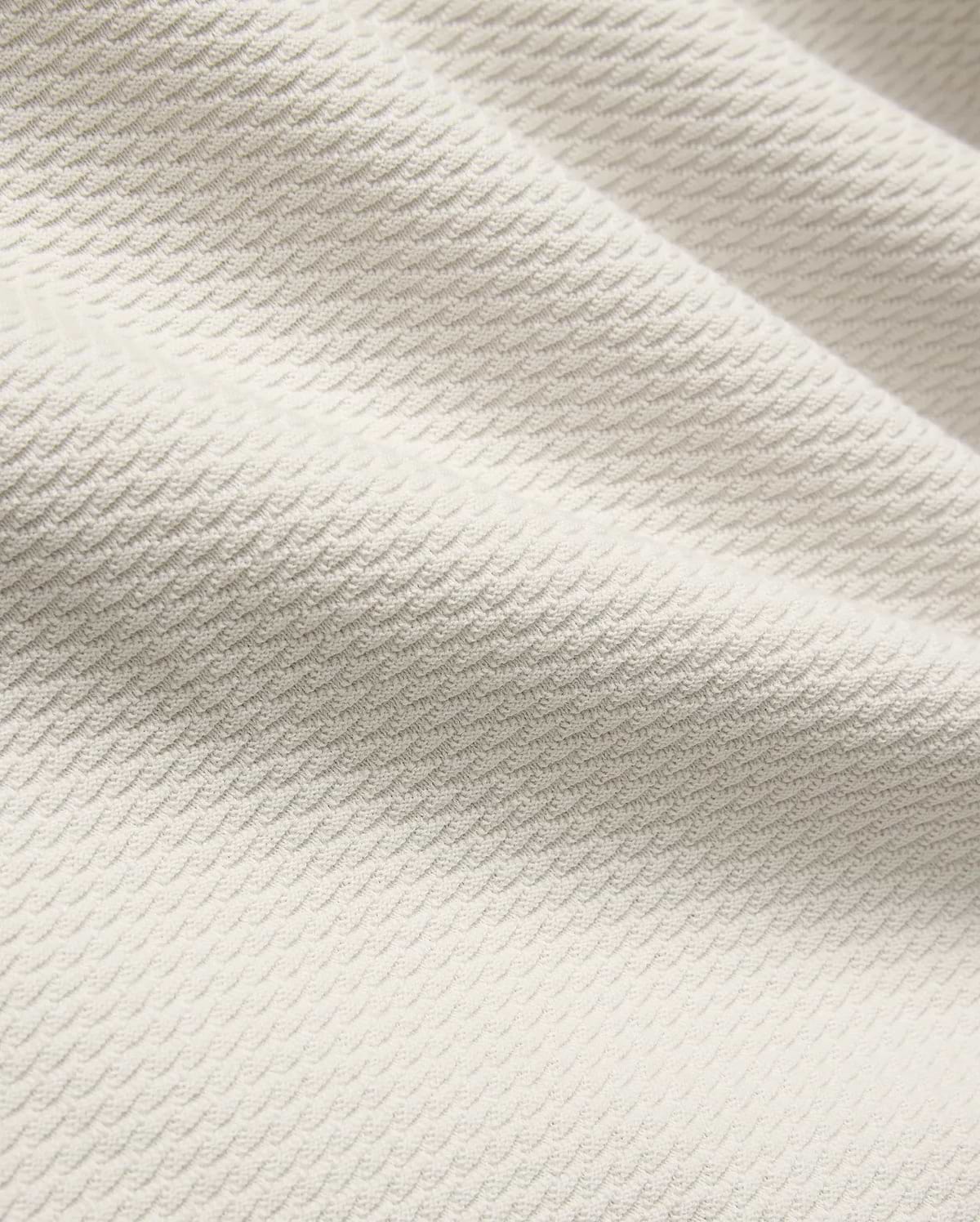 Mens Selby Knit Polo in a light cream hue, showcasing a premium textured knit fabric with a distinctive, subtle wave pattern, embodying refined streetwear style. (6)