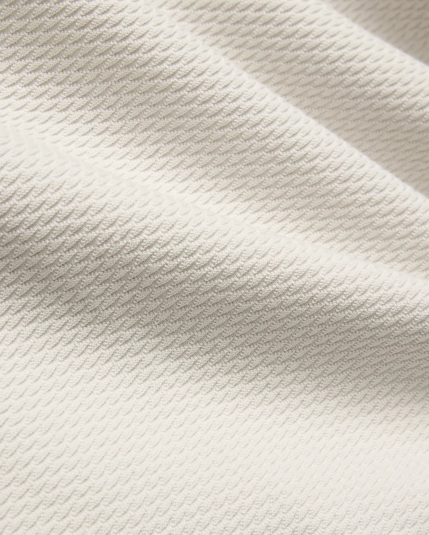 Mens Selby Knit Polo in a light cream hue, showcasing a premium textured knit fabric with a distinctive, subtle wave pattern, embodying refined streetwear style. (6)