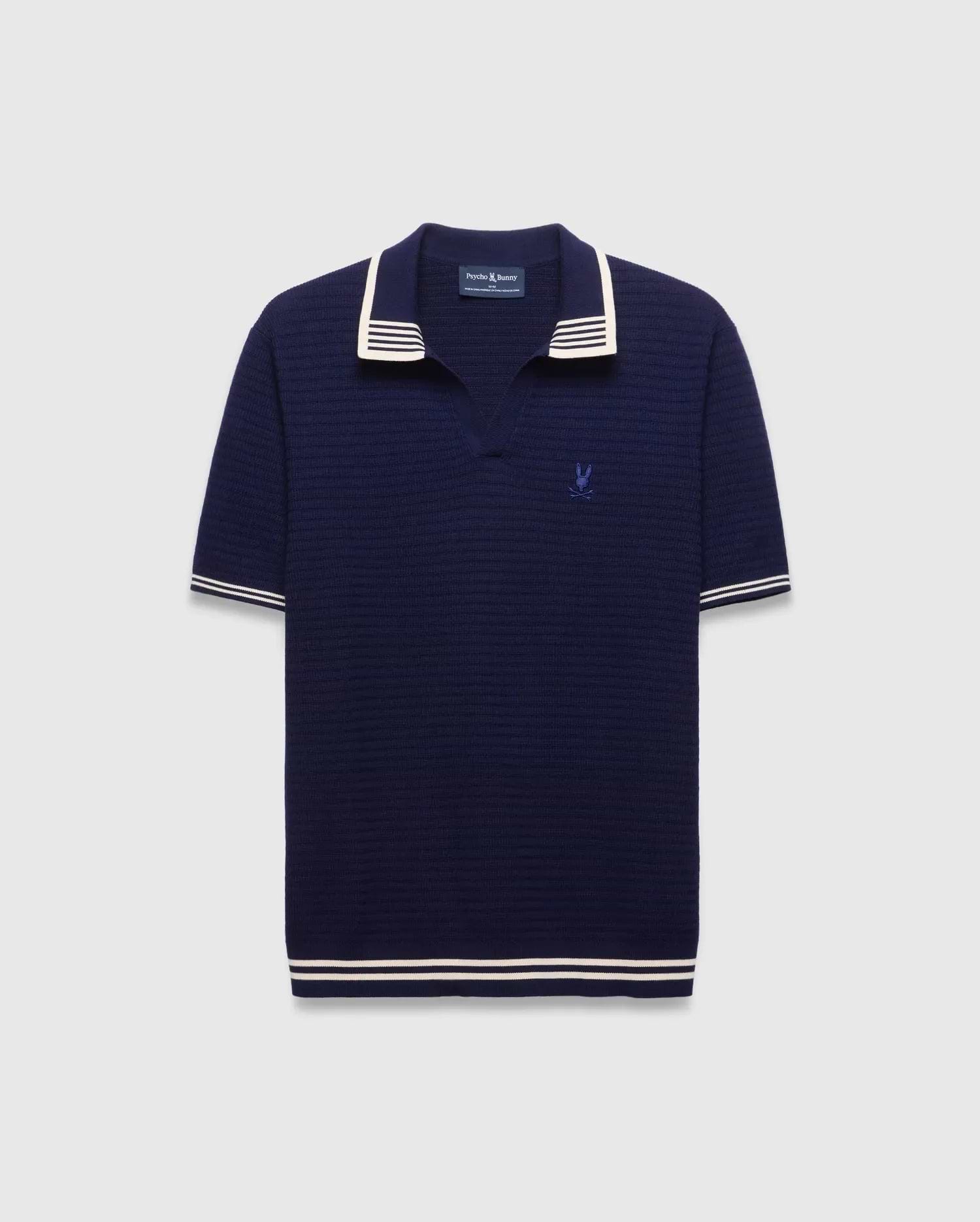 Mens Elowen Knit Polo in navy, featuring a textured knit fabric, white striped collar, cuffs, and hem, with a small embroidered Psycho Bunny skull logo on the left chest. (4)