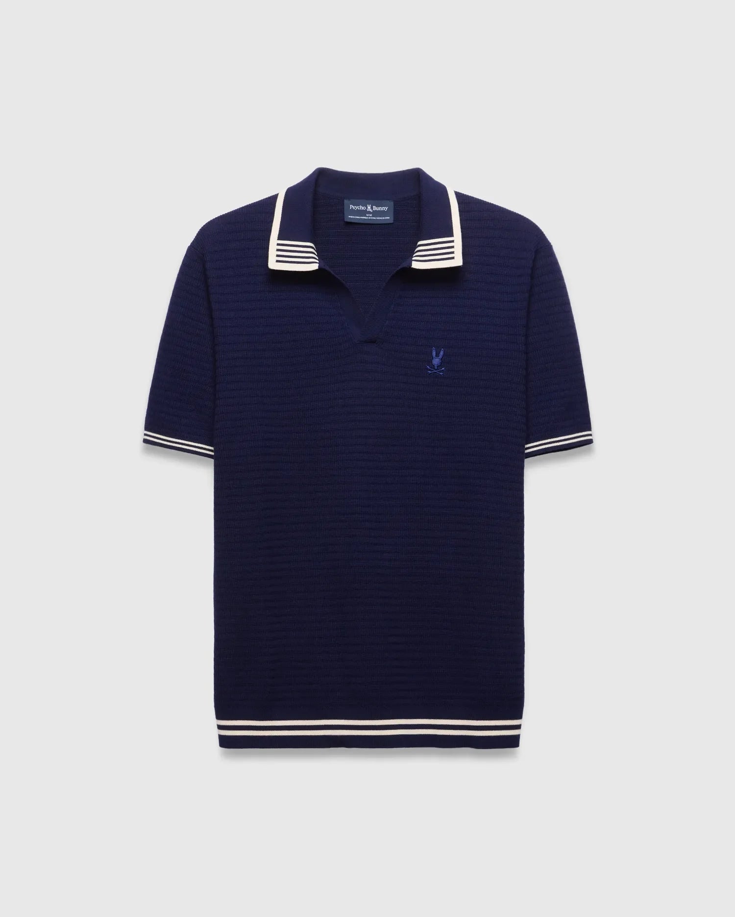 Mens Elowen Knit Polo in navy, featuring a textured knit fabric, white striped collar, cuffs, and hem, with a small embroidered Psycho Bunny skull logo on the left chest. (4)