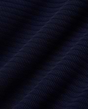 MENS ELOWEN KNIT POLO in deep navy blue, showcasing a finely crafted, horizontally ribbed knit texture with a soft, luxurious feel, characteristic of premium Psycho Bunny apparel. (5)