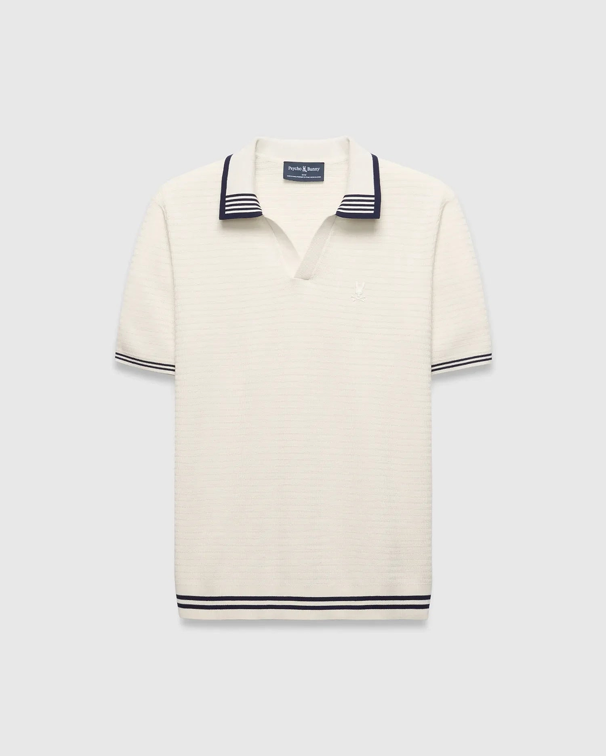 Mens Elowen Knit Polo, cream ribbed knit with navy striped V-neck collar, cuffs, and hem, featuring a small embroidered Psycho Bunny skull logo on the left chest. (4)