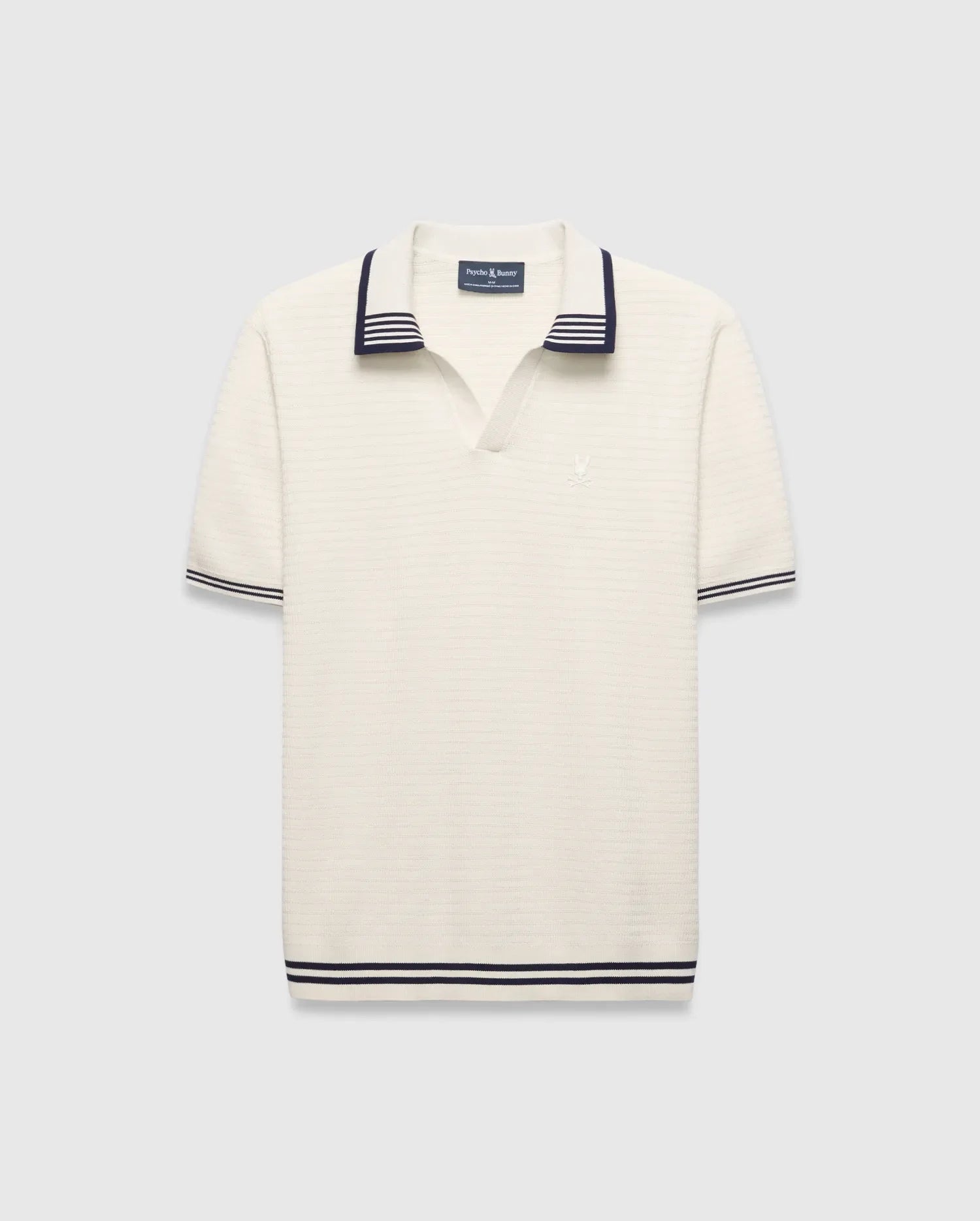 Mens Elowen Knit Polo, cream ribbed knit with navy striped V-neck collar, cuffs, and hem, featuring a small embroidered Psycho Bunny skull logo on the left chest. (4)