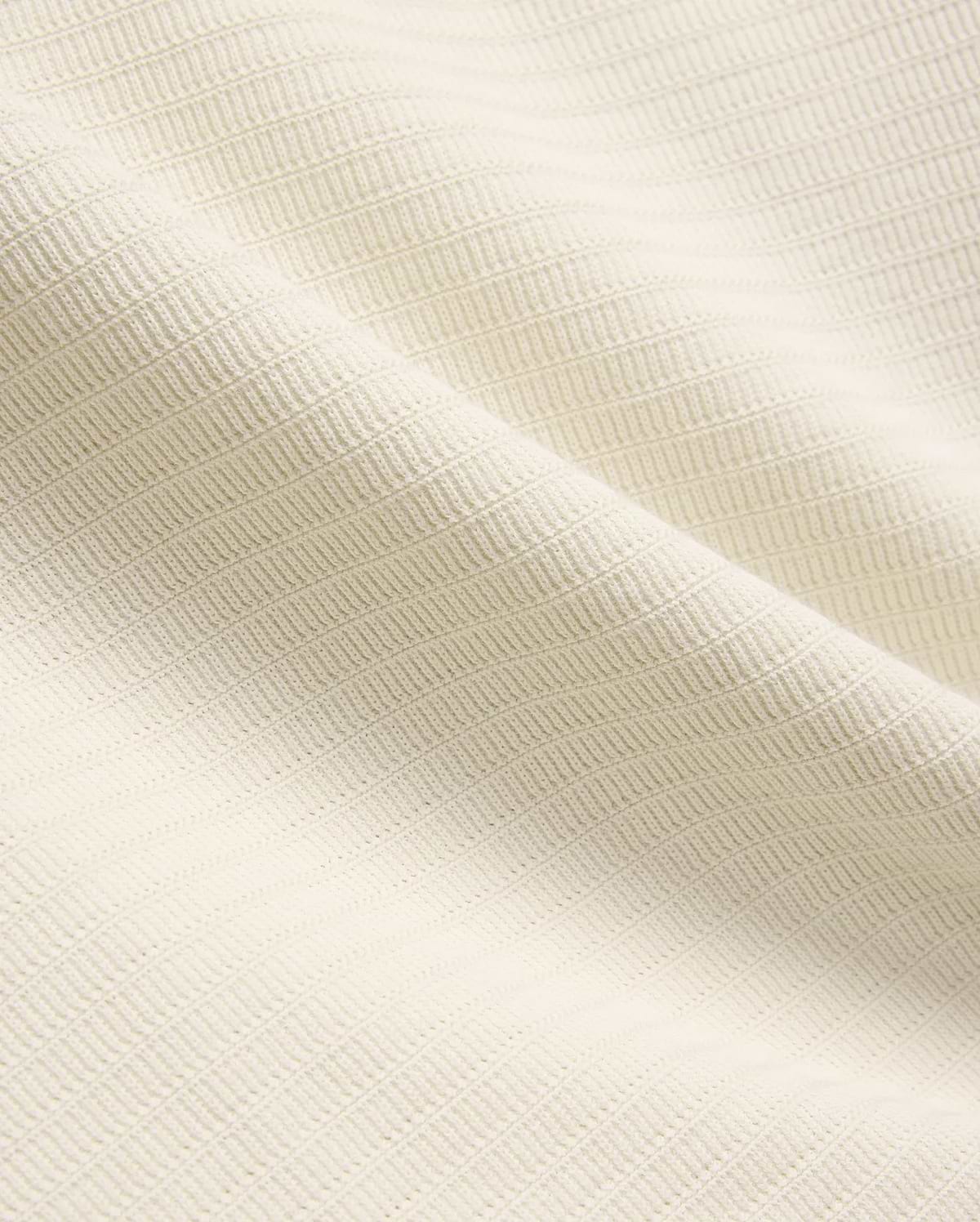 Mens Elowen Knit Polo in cream, showcasing a premium textured knit fabric with a fine horizontal rib pattern, embodying refined streetwear style. (5)