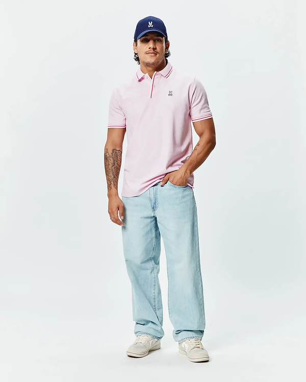 Mens Faye Pique Polo, a classic fit light pink pique knit polo with a small embroidered Psycho Bunny skull logo on the left chest and contrasting pink tipped collar and cuffs.