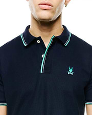 Men's Slade Pique Polo, a navy classic fit pique polo with teal and white tipped collar and cuffs, two-button placket, and small embroidered teal Psycho Bunny skull logo on left chest. (2)