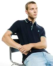 Men's Slade Pique Polo, navy classic fit pique polo with mint green and white tipped collar and cuffs, featuring a small embroidered Psycho Bunny skull logo on the left chest. (1)