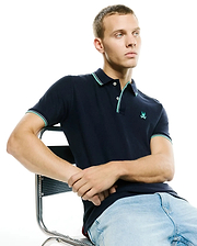 Men's Slade Pique Polo, navy classic fit pique polo with mint green and white tipped collar and cuffs, featuring a small embroidered Psycho Bunny skull logo on the left chest. (1)