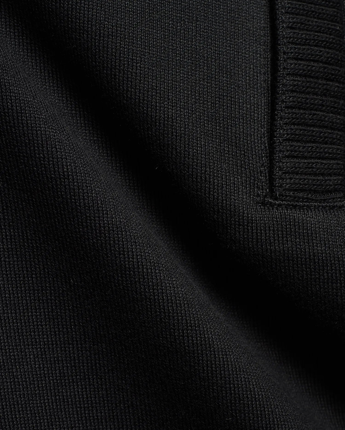 Men's Nolen Oversized Jersey Polo in rich black, highlighting its premium soft jersey knit fabric and a finely ribbed placket detail. (6)