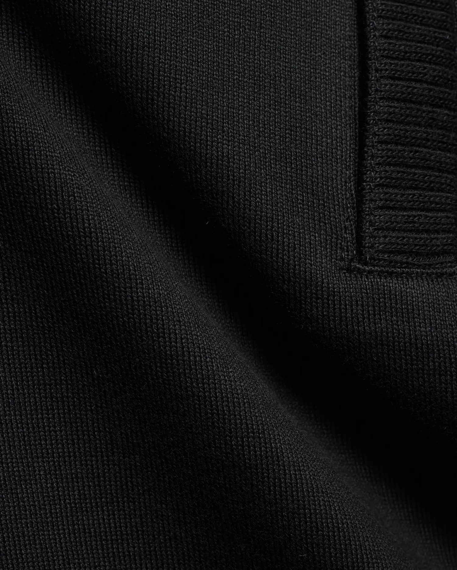 Men's Nolen Oversized Jersey Polo in rich black, highlighting its premium soft jersey knit fabric and a finely ribbed placket detail. (6)