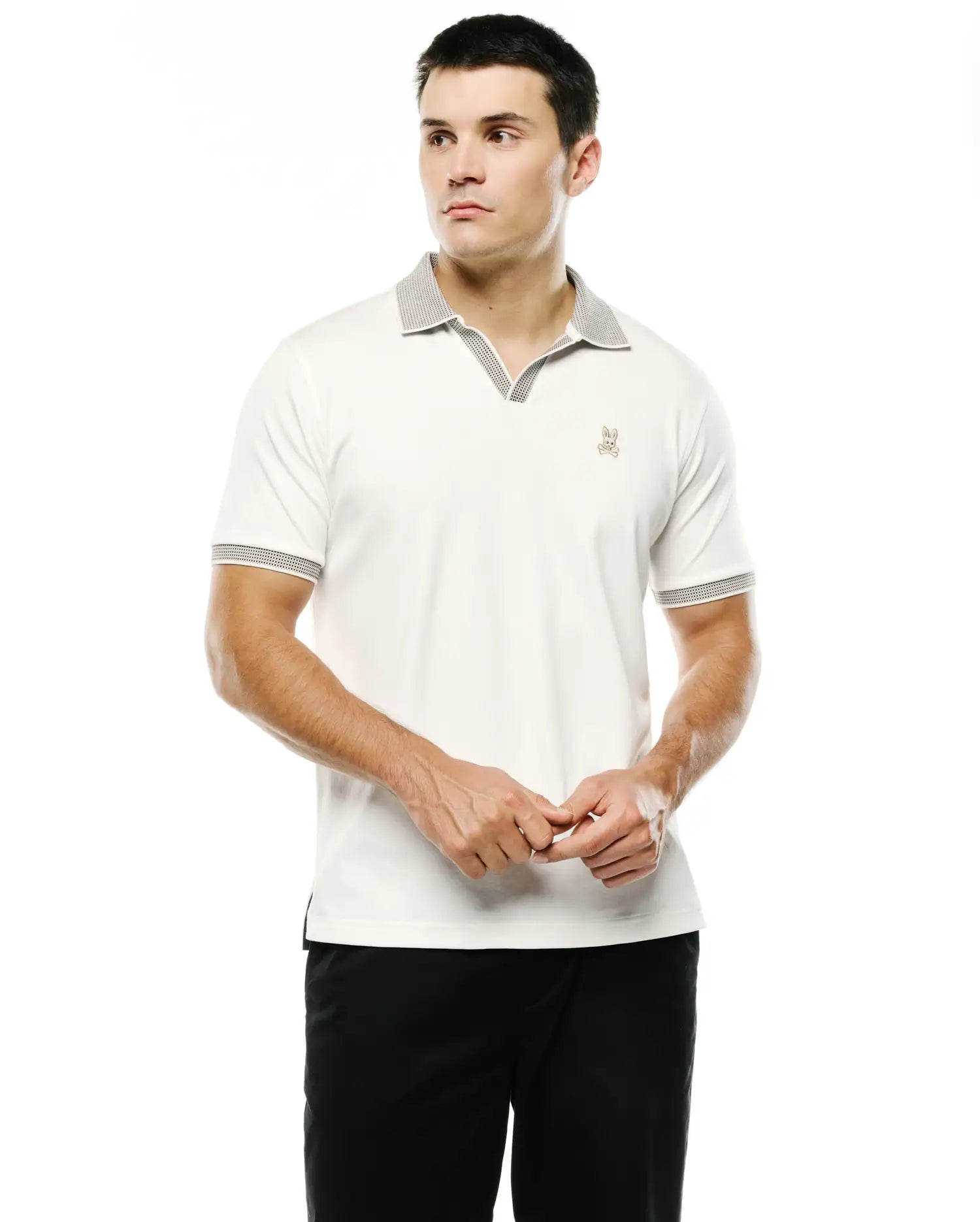 Men's Teddy Johnny Collar Polo, cream jersey knit with black/white micro-dot patterned Johnny collar and cuffs, and an embroidered tan Psycho Bunny skull logo on the left chest. (1)
