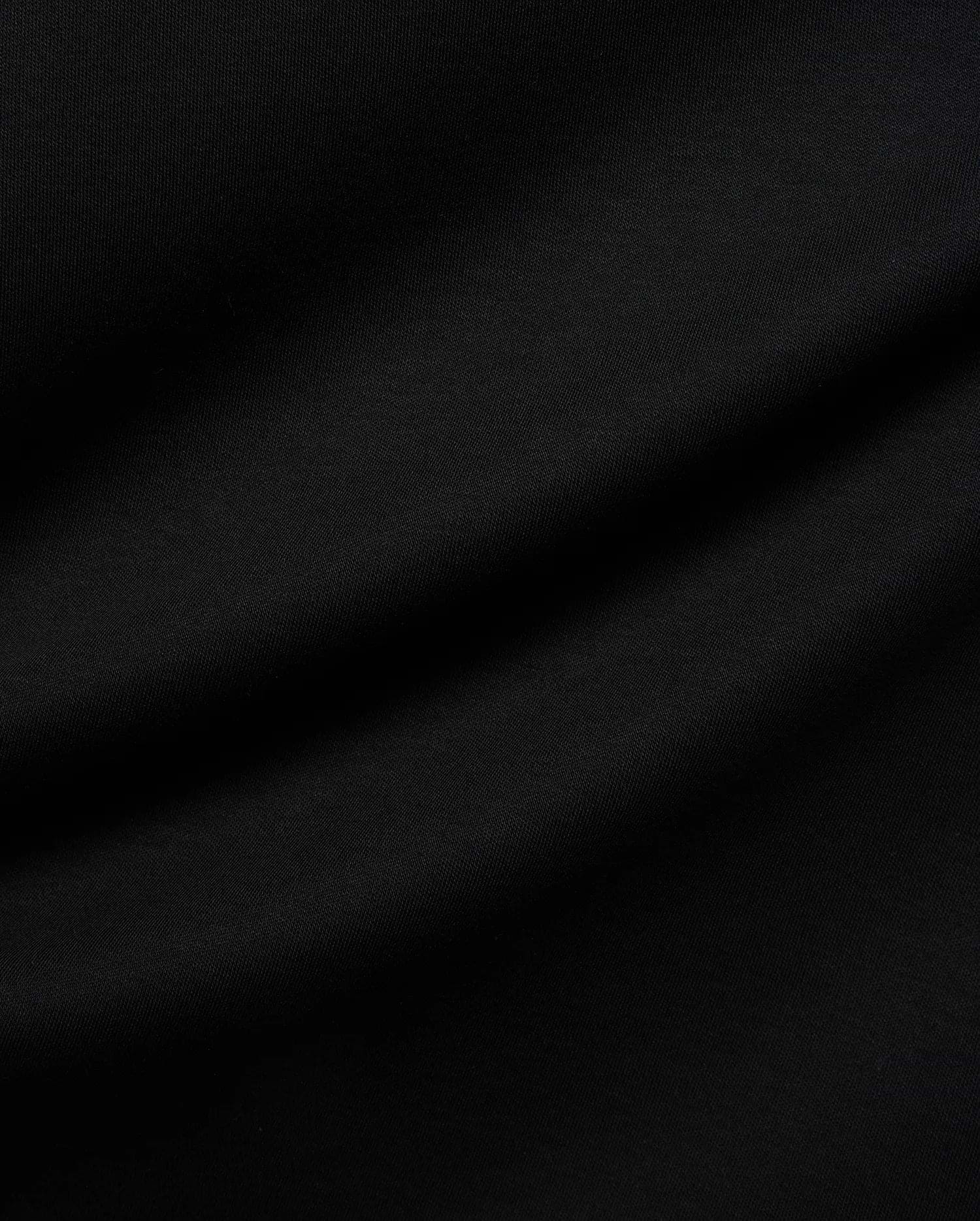 Mens Nasser Interlock Johnny Collar Polo in classic black, featuring smooth interlock fabric and the signature embroidered Psycho Bunny skull logo on the left chest.