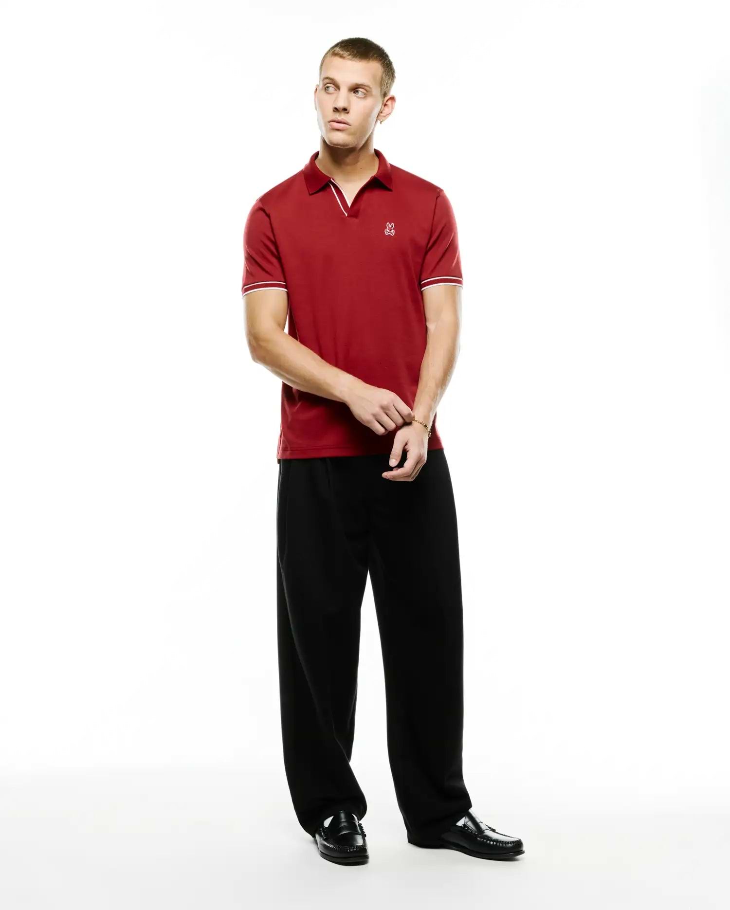 Men's Nasser Johnny Collar Polo in rich red pique, featuring a classic fit, white tipped Johnny collar, ribbed cuffs with white stripes, and a small embroidered Psycho Bunny skull logo on the left chest. (4)