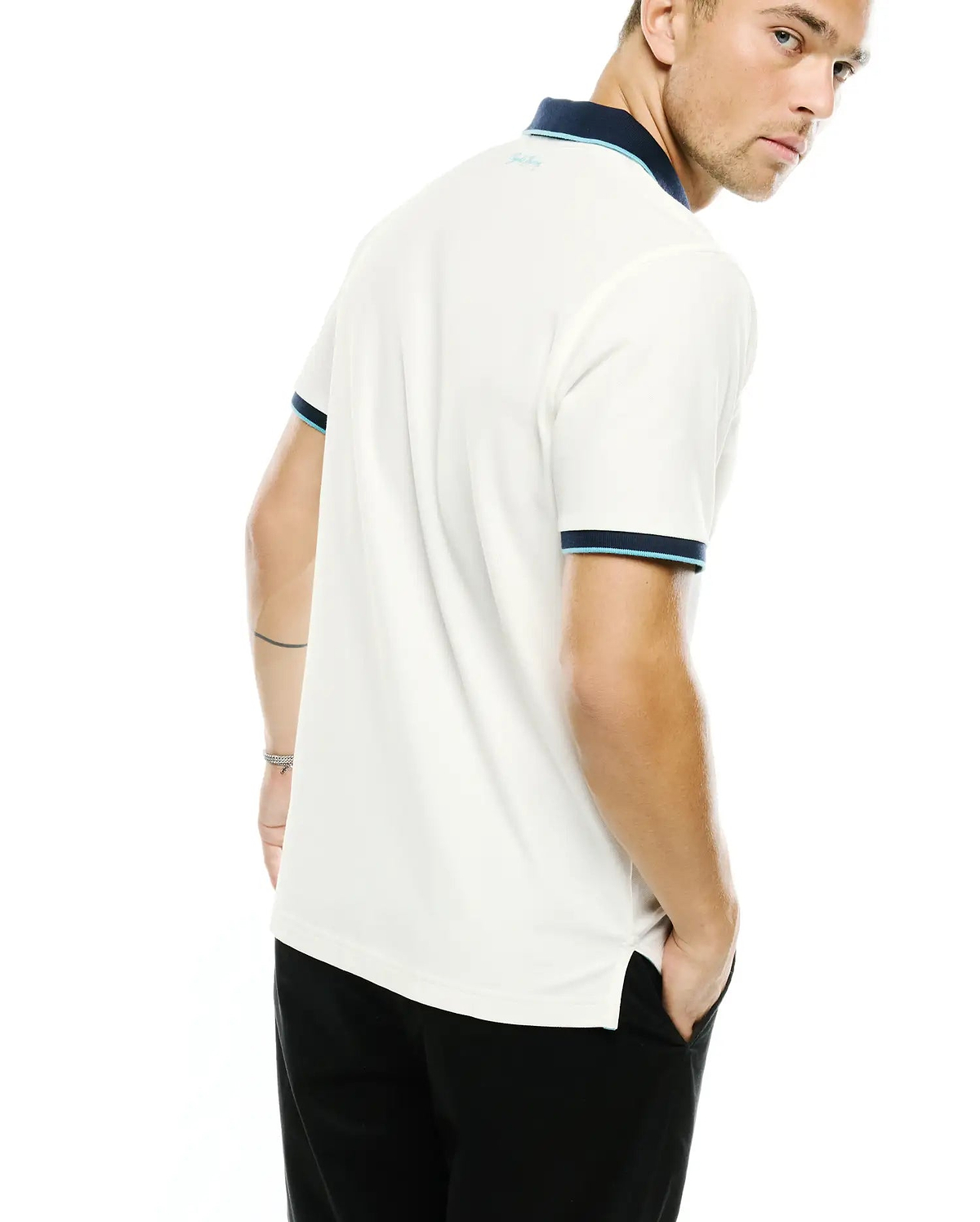 Men's Klaus Pique Polo, cream classic fit pique polo with navy and light blue tipped collar and cuffs, featuring a small light blue embroidered Psycho Bunny text logo on the back of the collar. (3)