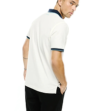 Men's Klaus Pique Polo, cream classic fit pique polo with navy and light blue tipped collar and cuffs, featuring a small light blue embroidered Psycho Bunny text logo on the back of the collar. (3)