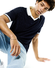 Mens Garry Jacquard Johnny Collar Polo in navy, featuring a subtle all-over Psycho Bunny skull jacquard pattern, a crisp white Johnny collar, and white double-striped sleeve cuffs, in a classic fit.