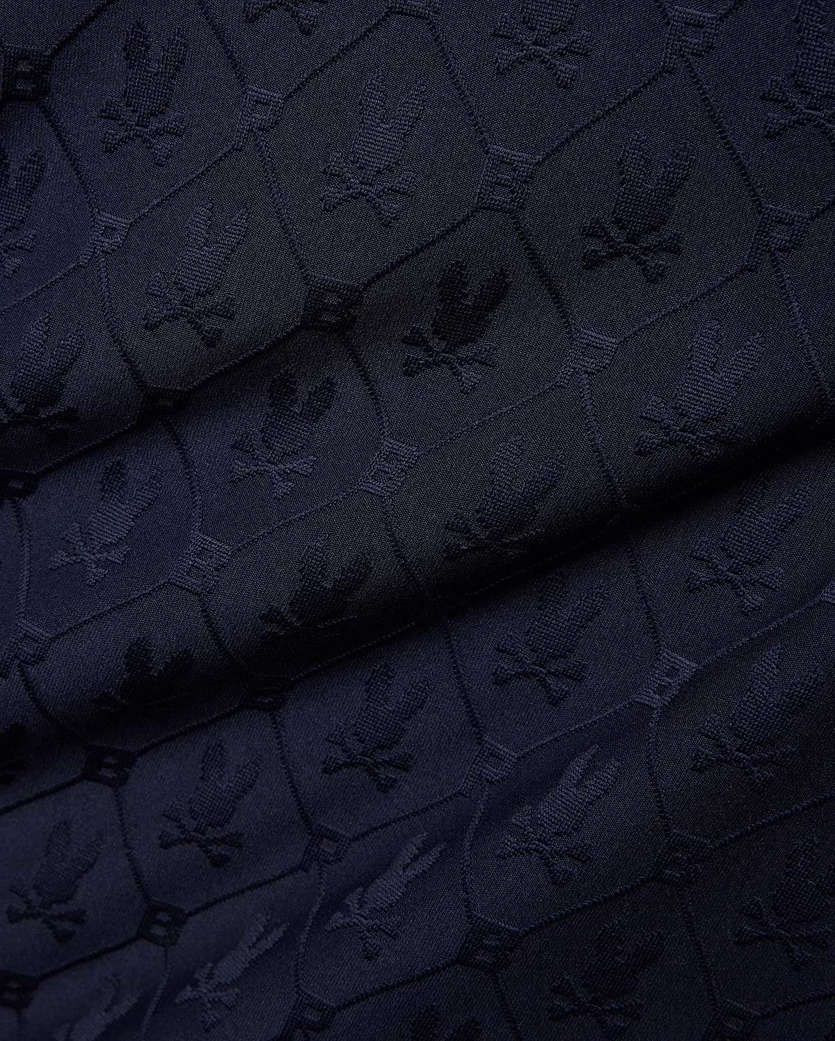 Mens Garry Jacquard Johnny Collar Polo in dark navy, featuring an all-over tone-on-tone jacquard knit pattern of the iconic Psycho Bunny skull logo within hexagonal shapes.