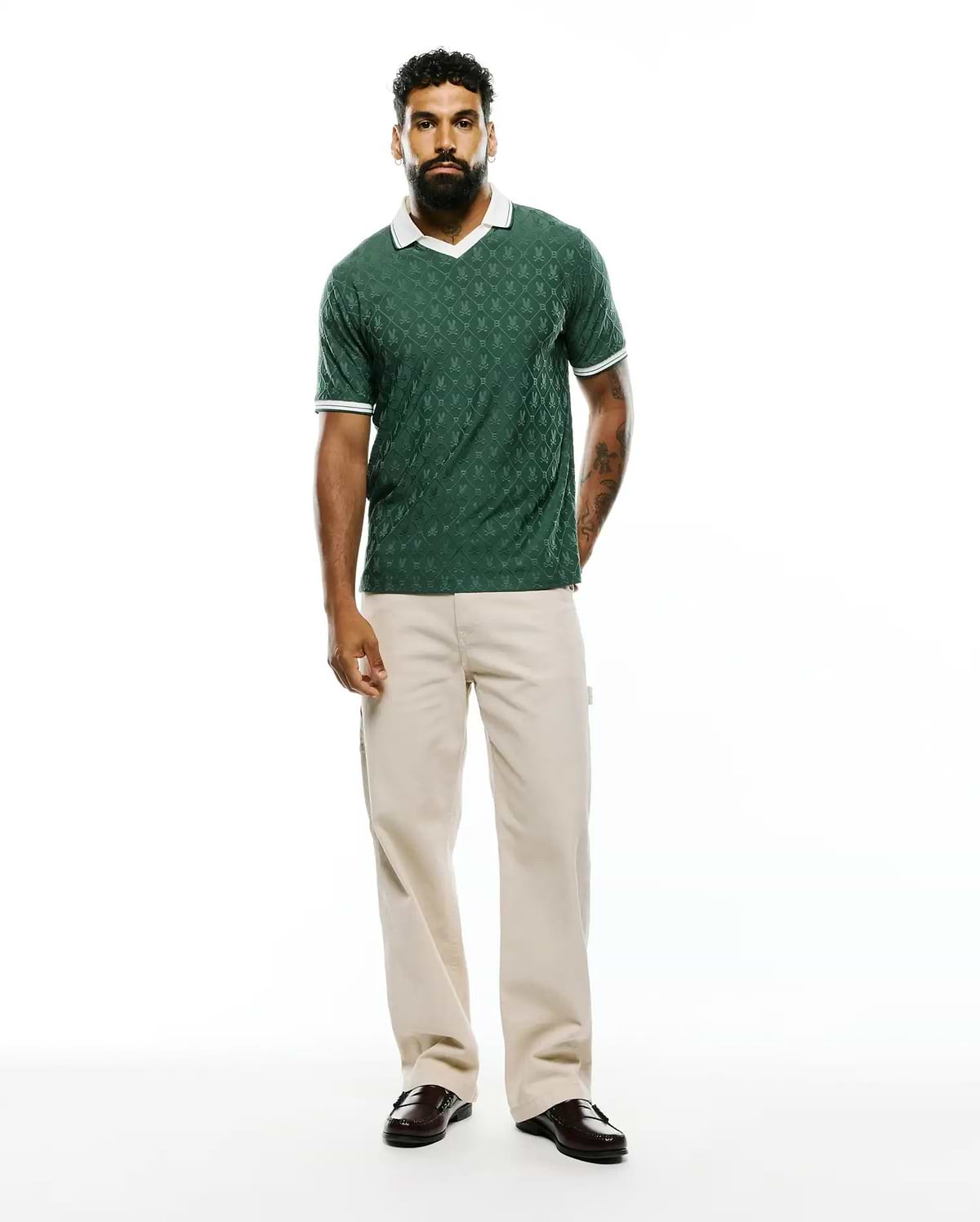 Mens Garry Jacquard Johnny Collar Polo in dark green, featuring an all-over bunny skull jacquard pattern, a white Johnny collar, and white striped cuffs, in a classic fit textured knit. (7)