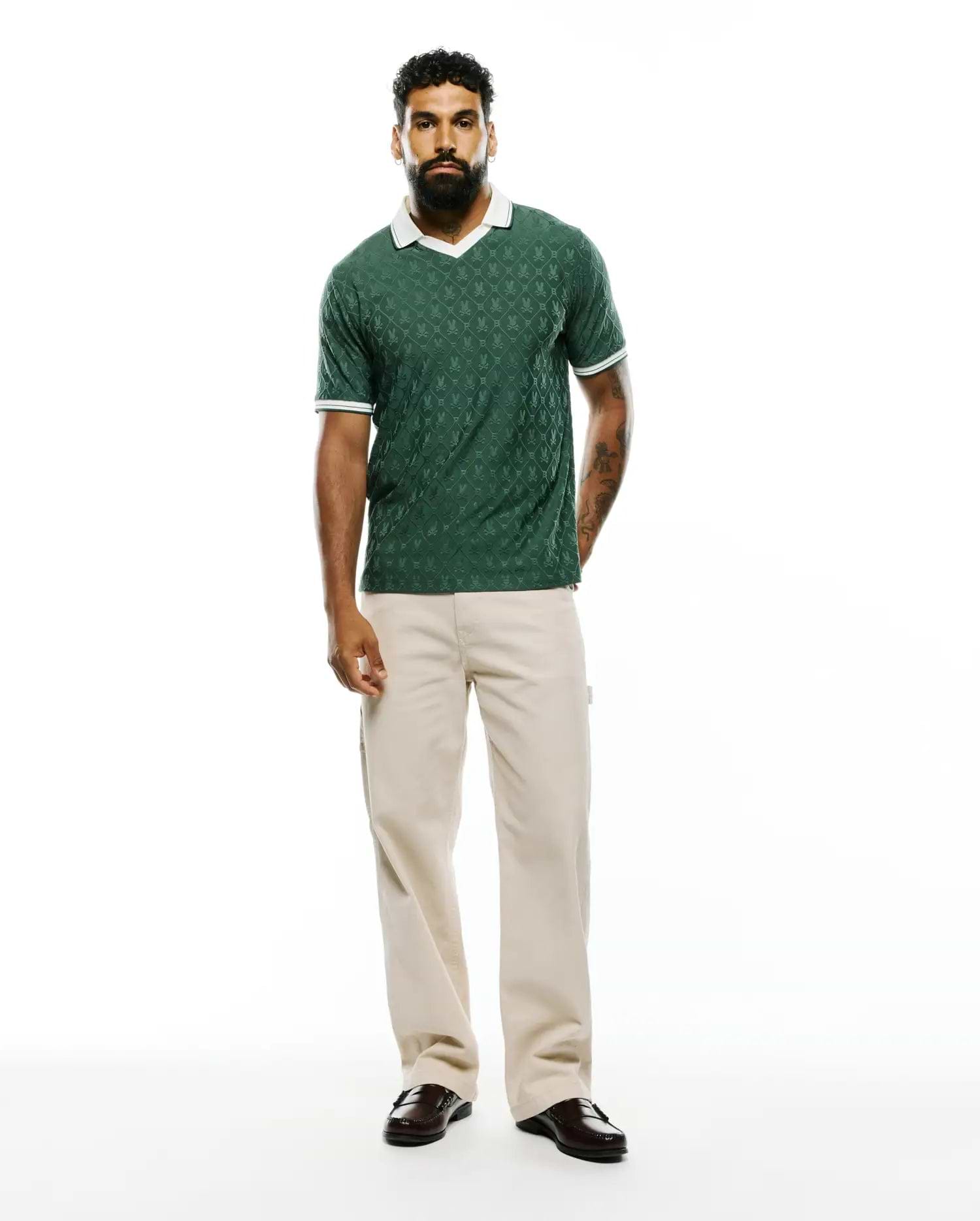 Mens Garry Jacquard Johnny Collar Polo in dark green, featuring an all-over bunny skull jacquard pattern, a white Johnny collar, and white striped cuffs, in a classic fit textured knit. (7)