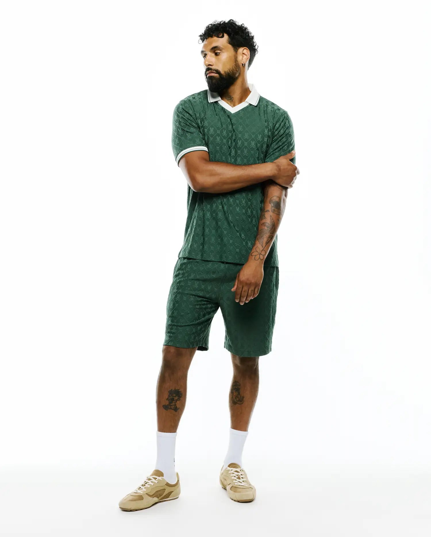Dark green Mens Garry Jacquard Johnny Collar Polo and matching shorts, featuring an all-over Psycho Bunny skull logo jacquard pattern, classic fit, and white collar with sleeve trim. (2)