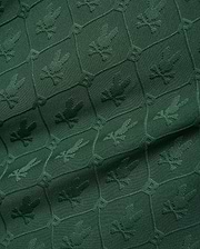 Mens Garry Jacquard Johnny Collar Polo in deep green, featuring an all-over tonal jacquard pattern of the iconic Psycho Bunny skull logo within a hexagonal grid. (9)