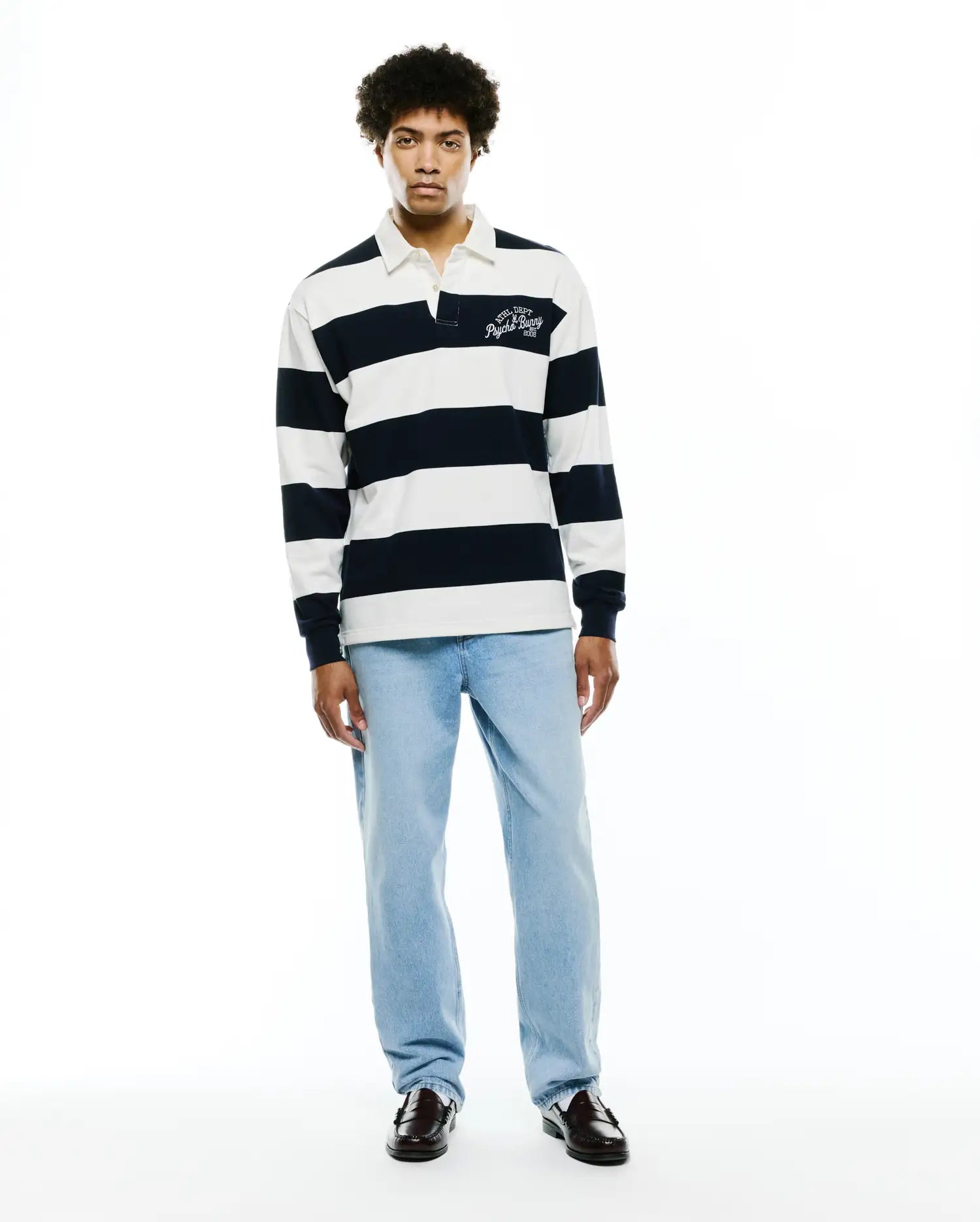 Mens Keven Ls Relaxed Fit Polo, a navy and white striped jersey knit with a white collar and an embroidered ATHL. DEPT Psycho Bunny EST. 2005 logo on the left chest.
