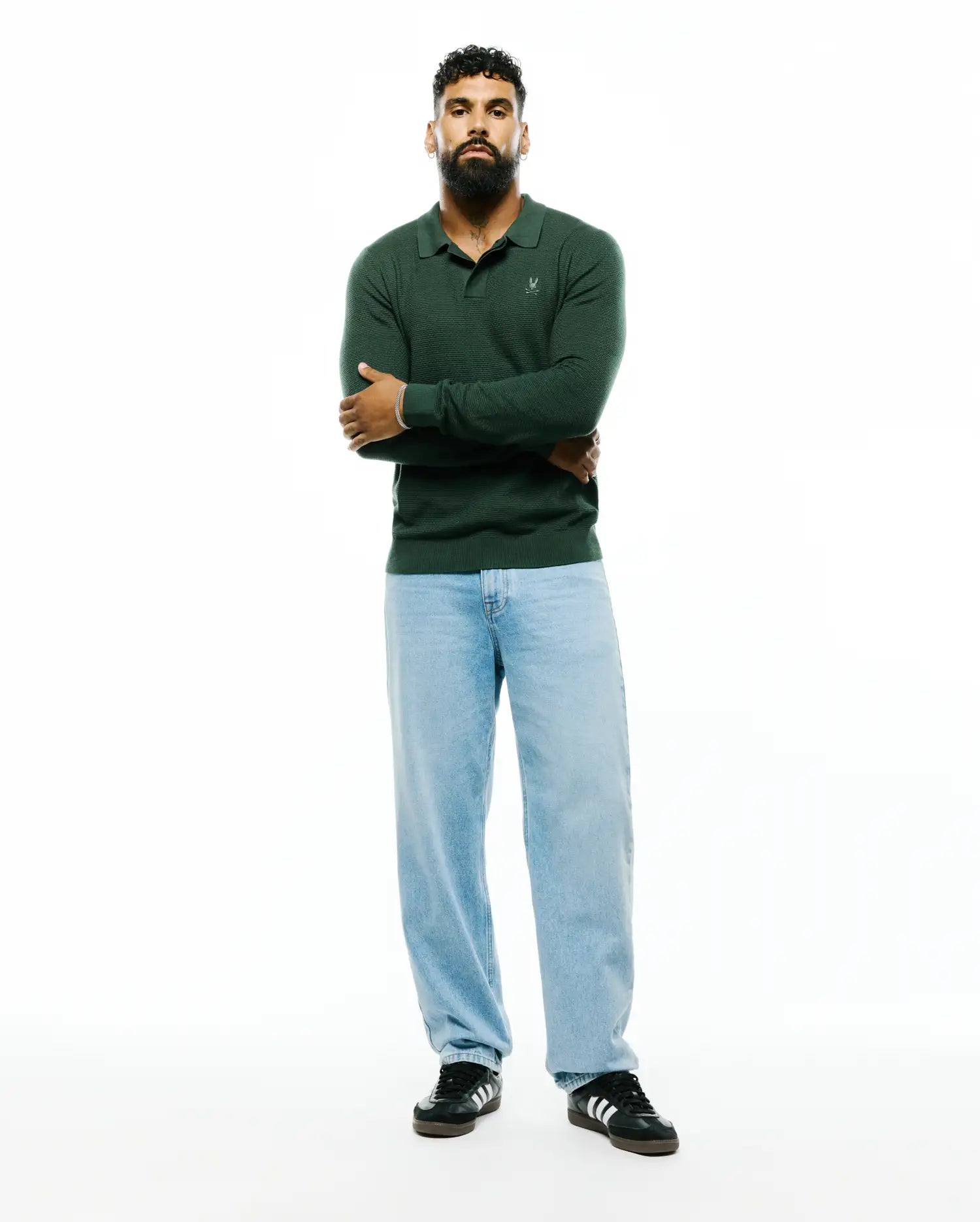 Mens Leroy Long Sleeve Knit Polo in deep forest green, featuring a classic fit, textured knit fabric, and a small white embroidered Psycho Bunny skull logo on the left chest.