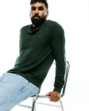 MENS LEROY LONG SLEEVE KNIT POLO in deep forest green, featuring a textured knit fabric, classic collar, ribbed cuffs, and a small embroidered Psycho Bunny skull logo on the left chest.
