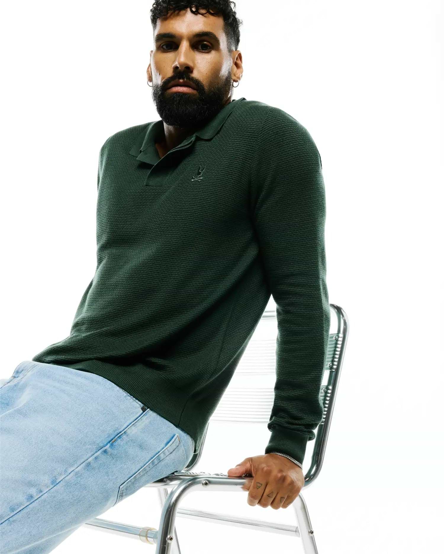 MENS LEROY LONG SLEEVE KNIT POLO in deep forest green, featuring a textured knit fabric, classic collar, ribbed cuffs, and a small embroidered Psycho Bunny skull logo on the left chest.