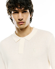 Mens Leroy Long Sleeve Knit Polo in cream, featuring a classic fit, a distinctive ribbed knit texture, and a small, tone-on-tone embroidered Psycho Bunny skull logo on the left chest.