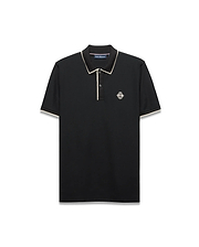 Mens Robin Pique Polo, black classic fit with cream piping on the collar and cuffs, featuring a textured pique fabric and an embroidered Psycho Bunny skull logo on the left chest.