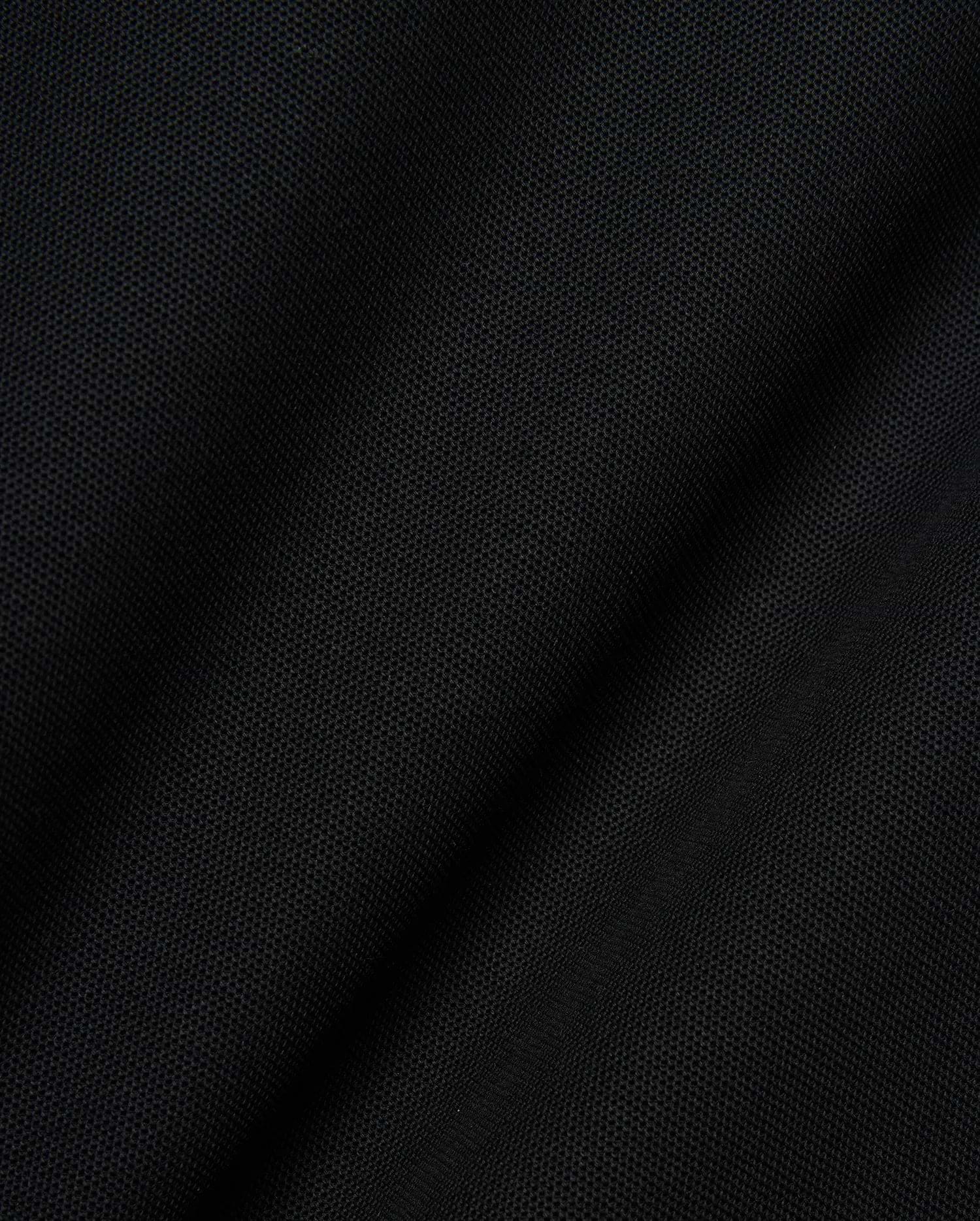 Mens Robin Pique Polo, a premium black pique knit fabric showcasing its distinctive textured weave and subtle drape, embodying Psycho Bunny's refined streetwear quality.