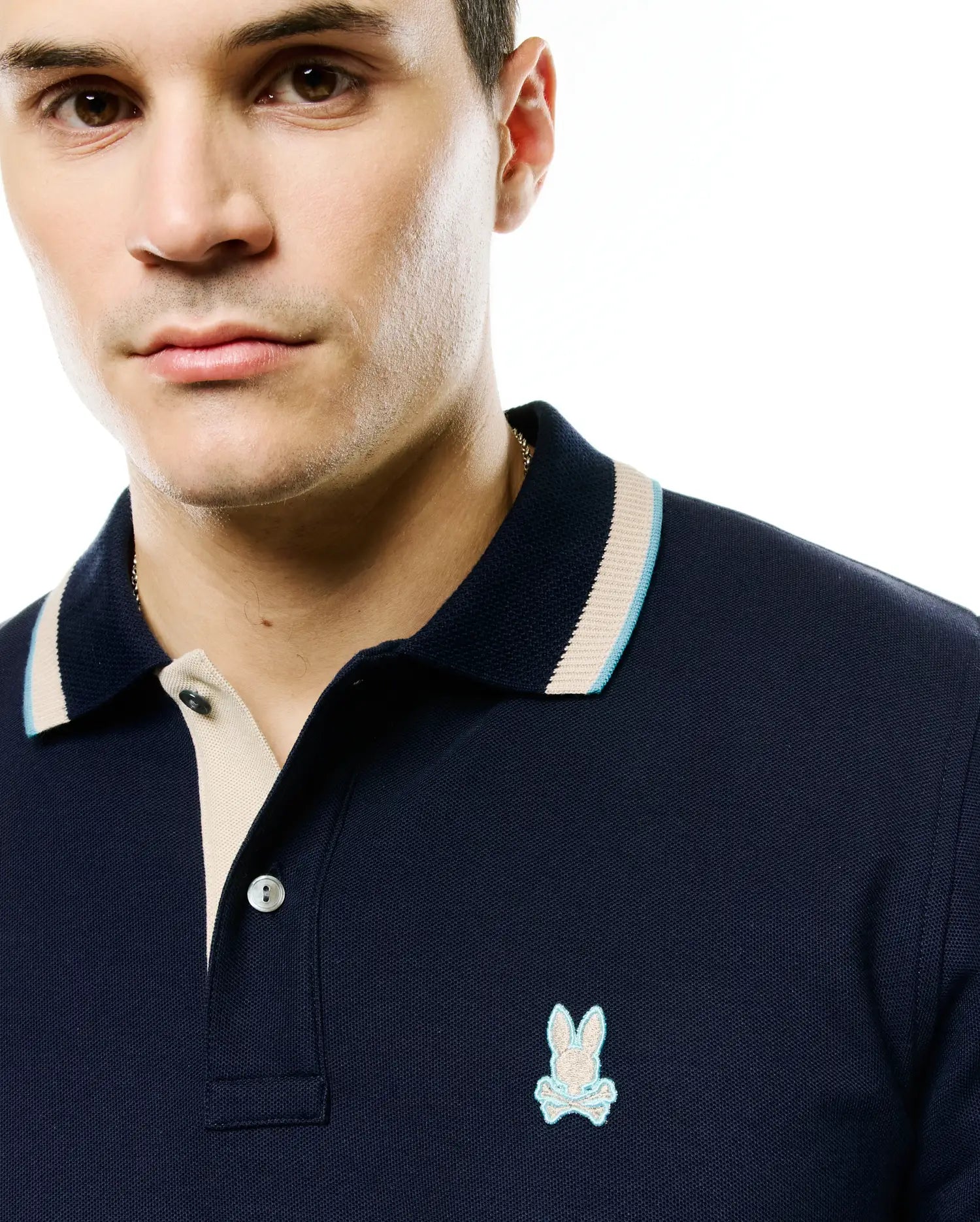 Men's Grover Pique Longsleeve Polo: Navy blue pique knit, classic fit, beige placket, ribbed collar with light blue/beige tipping, small embroidered light blue Psycho Bunny skull logo left chest. (2)