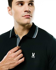 Men's Grover Pique Longsleeve Polo in dark green pique, featuring a classic fit, ribbed collar with grey and white stripes, grey placket, and a small embroidered white Psycho Bunny skull logo on the left chest. (2)