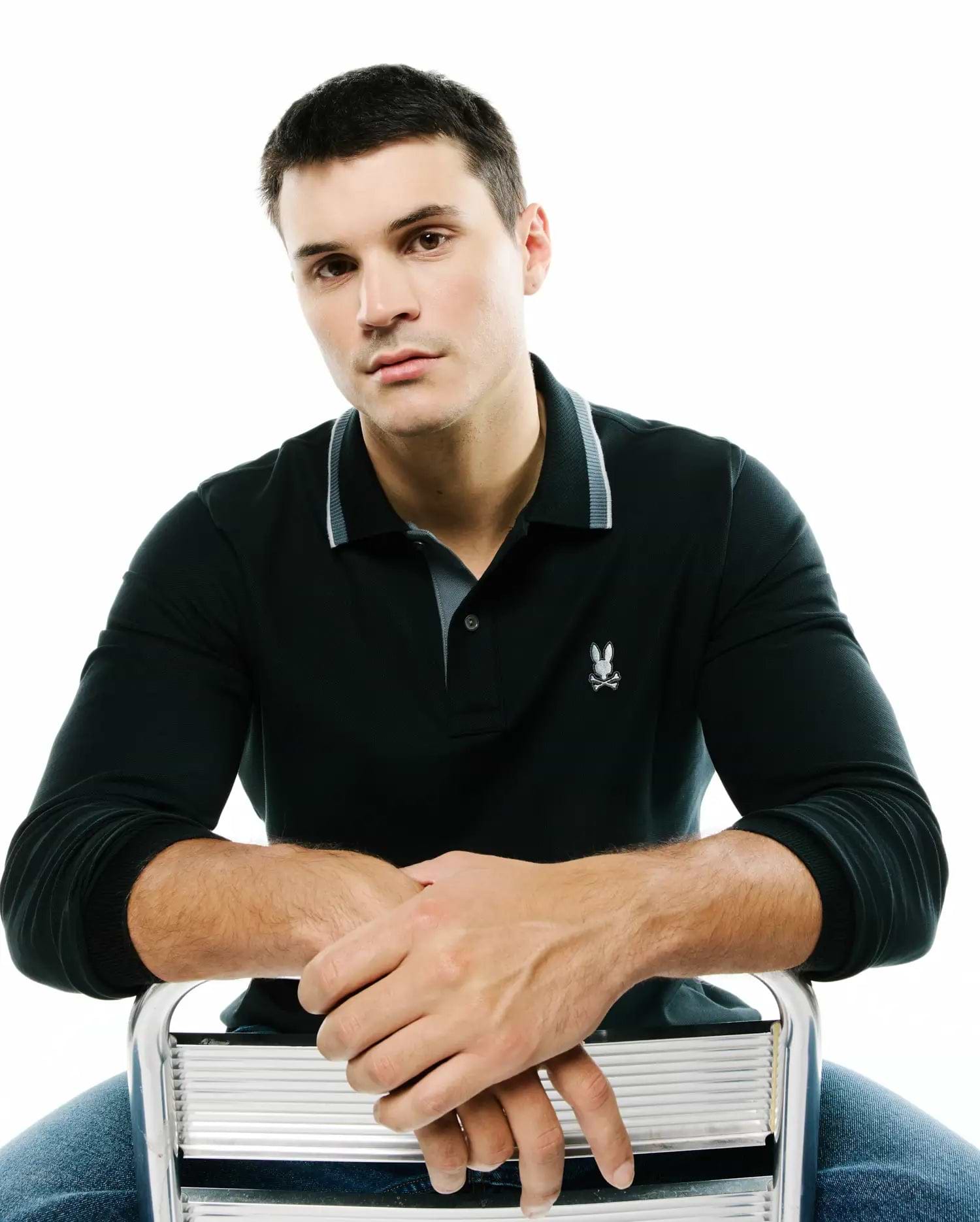 Men's Grover Pique Longsleeve Polo, deep green classic fit pique with a two-button placket, grey-lined striped collar, ribbed cuffs, and a white embroidered Psycho Bunny skull logo on the left chest. (3)