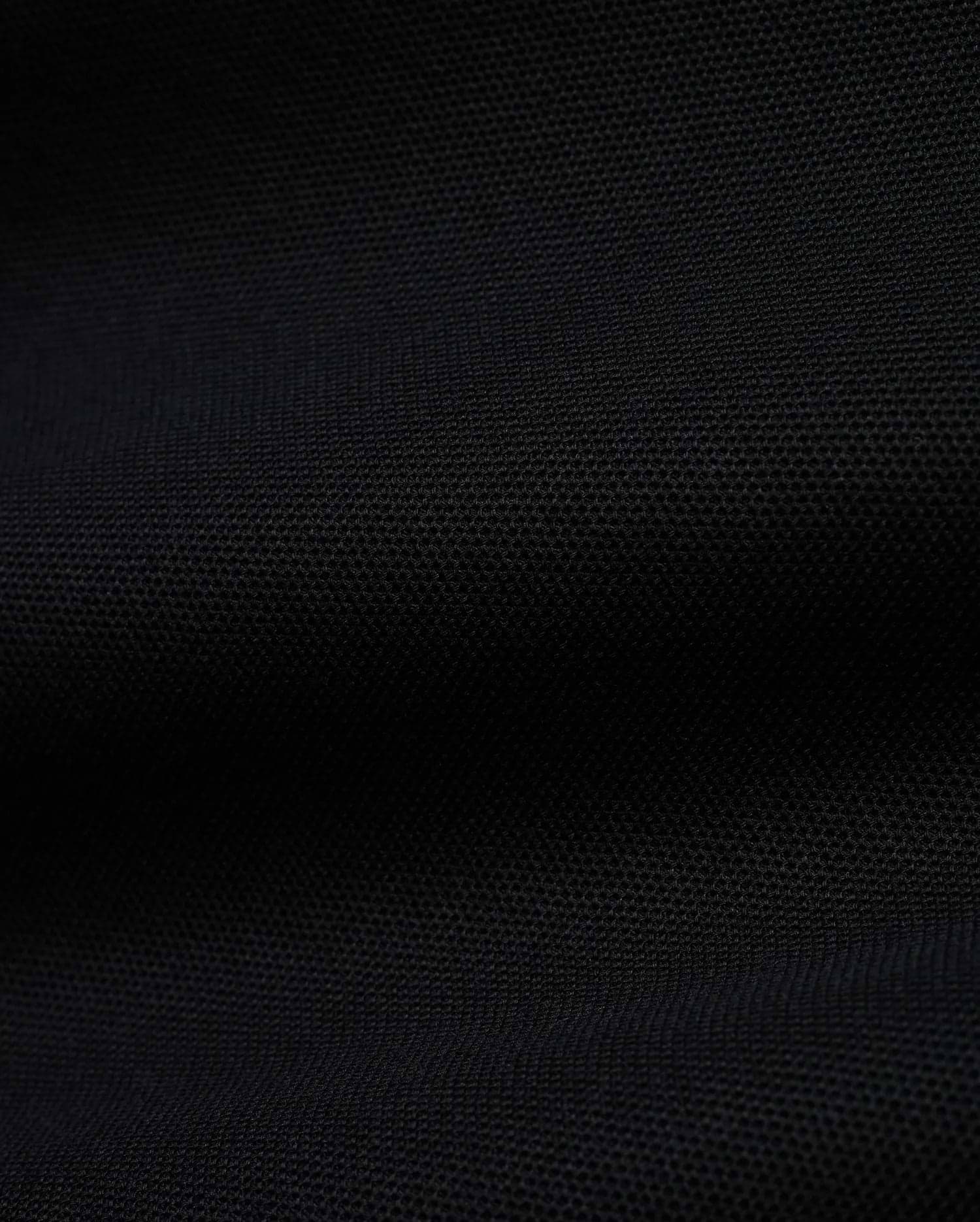 Men's Grover Pique Longsleeve Polo in rich black, showcasing its premium, finely textured pique knit fabric, a versatile and comfortable staple for sophisticated streetwear. (6)
