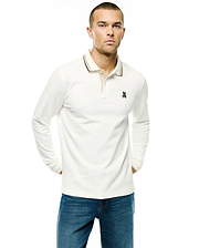 Men's Grover Pique Longsleeve Polo in cream, featuring a classic fit, pique texture, beige inner placket, black tipped ribbed collar, and a small embroidered Psycho Bunny skull logo on the left chest. (1)