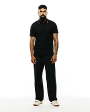 Premium Black Mens Ringston Pique Polo, classic fit, with white tipping on the collar and cuffs, featuring a small embroidered Psycho Bunny skull logo on the left chest.
