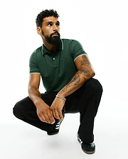 Mens Ringston Pique Polo in dark green, featuring a classic fit, pique knit fabric, white tipping on the collar and cuffs, and a small embroidered Psycho Bunny skull logo on the left chest.