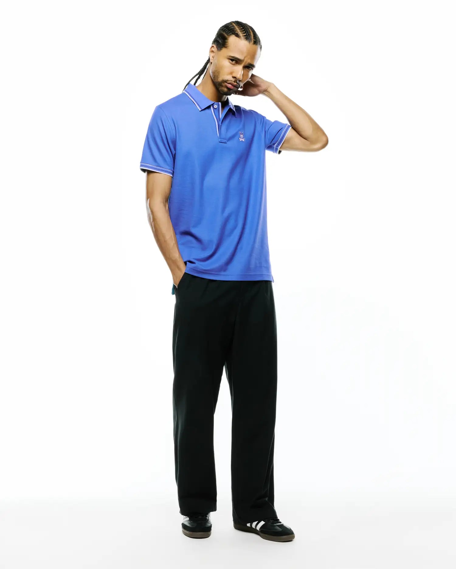 Mens Atley Pique Polo in vibrant blue, featuring a classic fit, white tipping on the collar and sleeve cuffs, and a small embroidered Psycho Bunny skull logo on the left chest. (4)