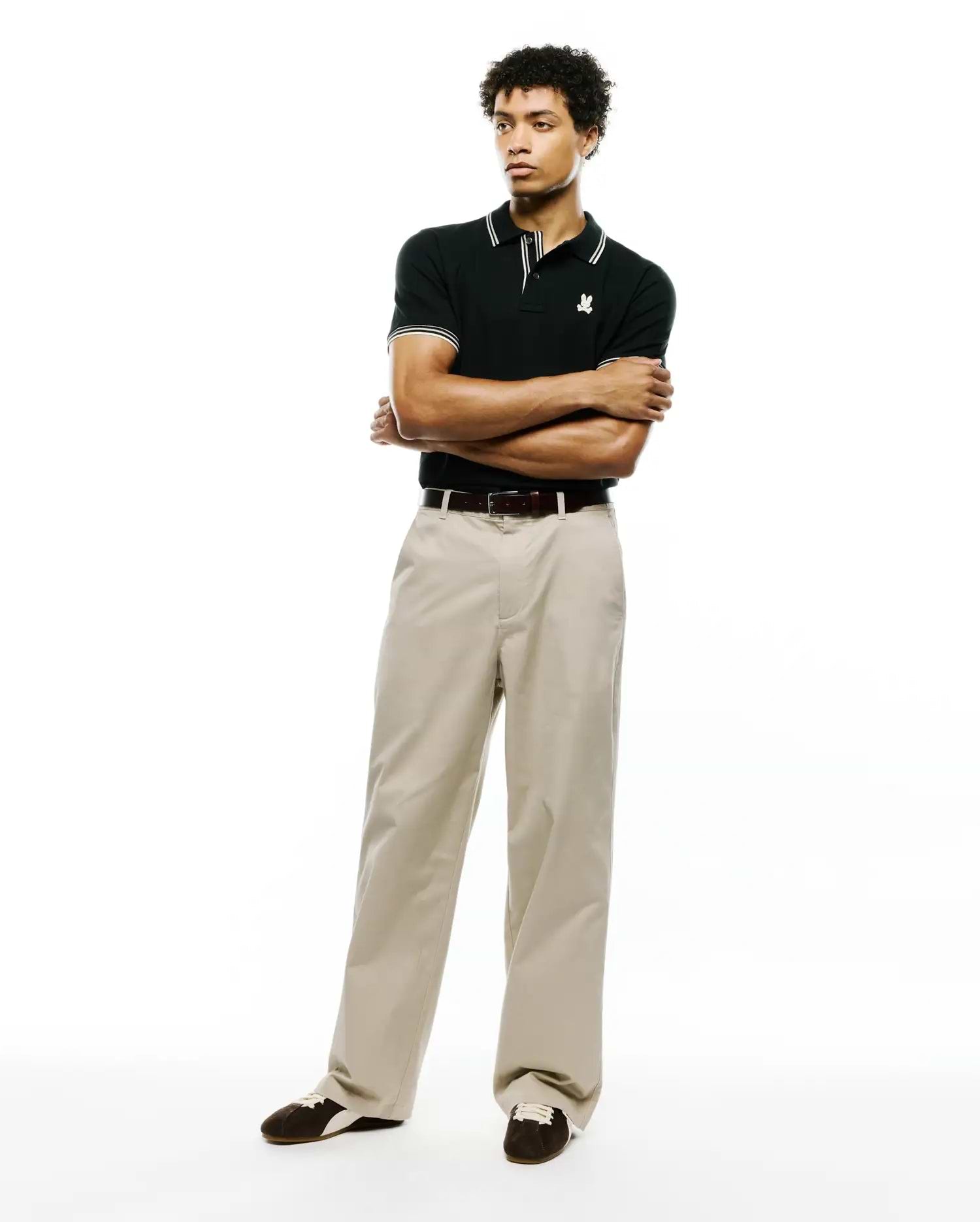 Black Mens Atley Pique Polo with a classic fit, featuring a pique texture, white double-stripe collar and cuffs, and a small embroidered white Psycho Bunny skull logo on the left chest. (4)