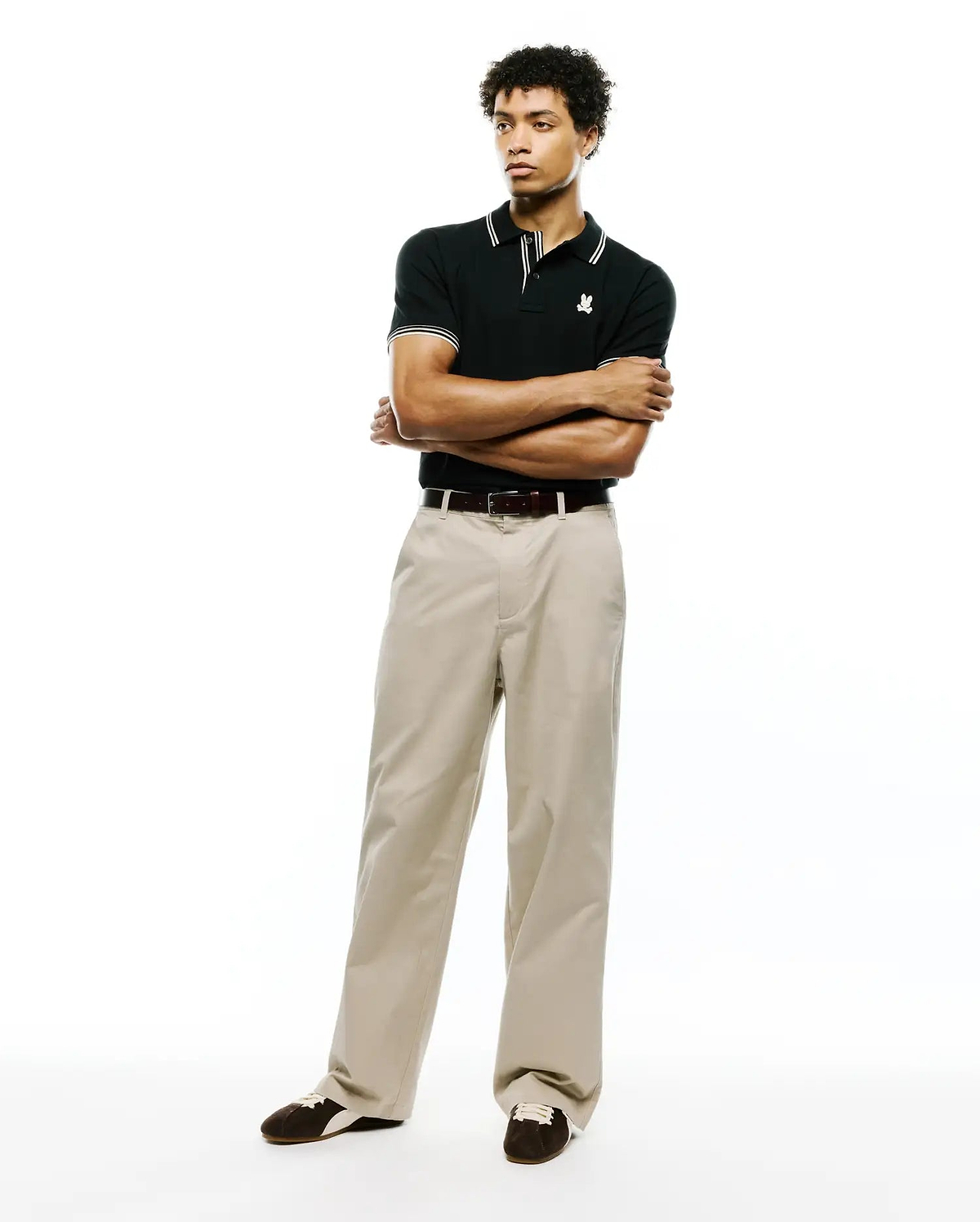 Black Mens Atley Pique Polo with a classic fit, featuring a pique texture, white double-stripe collar and cuffs, and a small embroidered white Psycho Bunny skull logo on the left chest. (4)