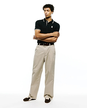 Black Mens Atley Pique Polo with a classic fit, featuring a pique texture, white double-stripe collar and cuffs, and a small embroidered white Psycho Bunny skull logo on the left chest. (4)
