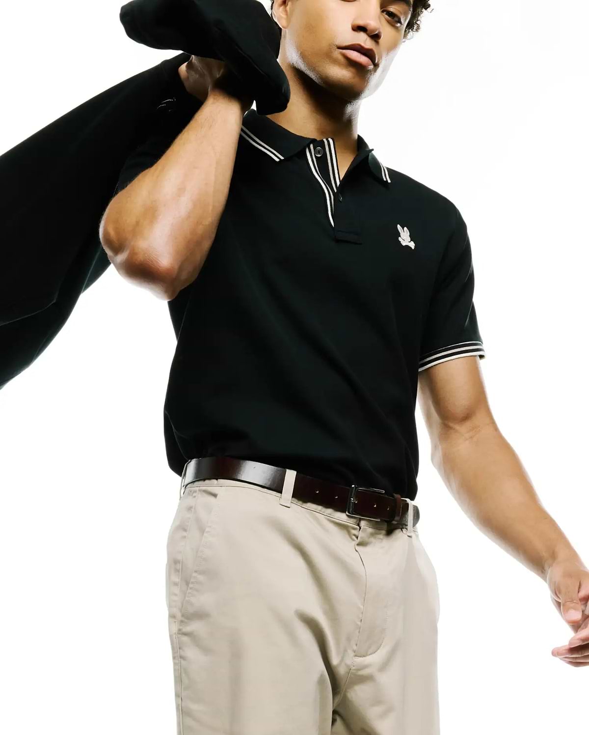 MENS ATLEY PIQUE POLO, a classic fit black pique polo with white double-stripe tipped collar and cuffs, featuring a small embroidered Psycho Bunny skull logo on the left chest. (3)