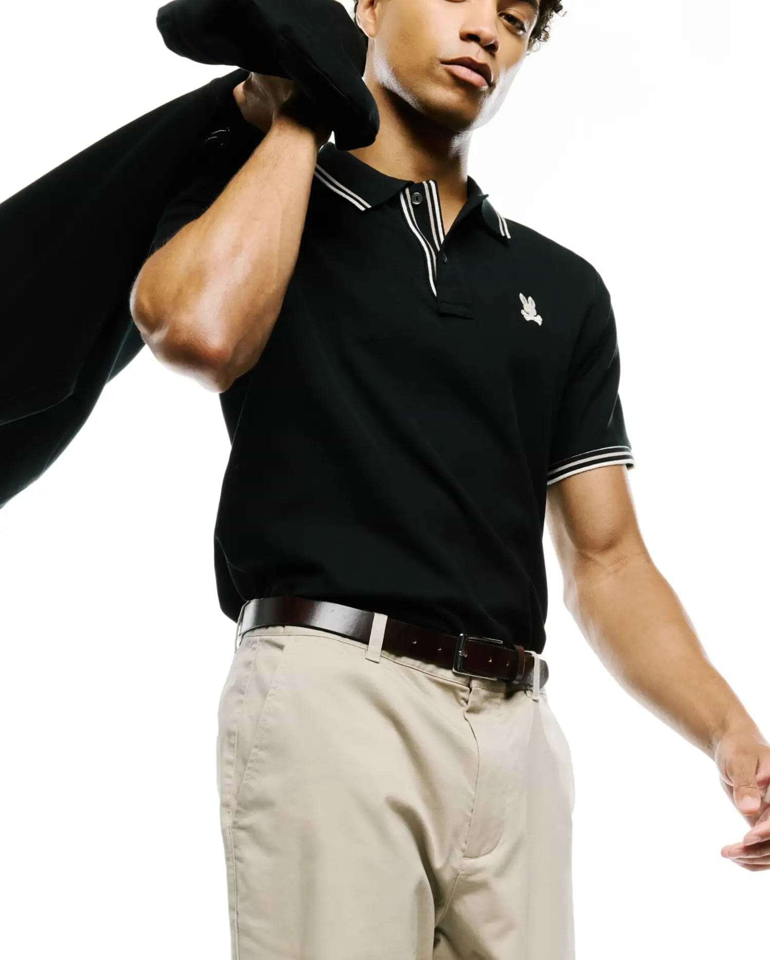 MENS ATLEY PIQUE POLO, a classic fit black pique polo with white double-stripe tipped collar and cuffs, featuring a small embroidered Psycho Bunny skull logo on the left chest. (3)