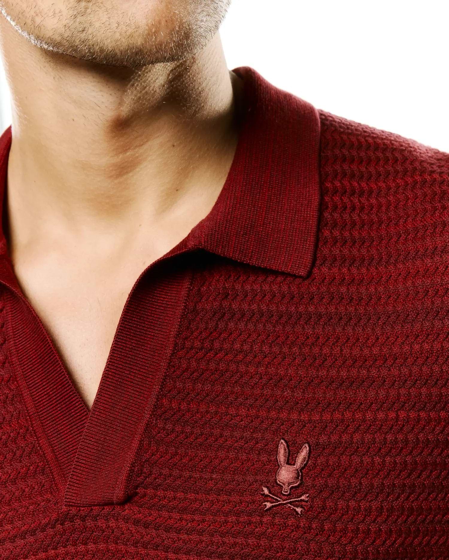 Men's Devon Braided Knit Polo in deep red, featuring a textured braided knit fabric, ribbed V-neck collar, and a small, tonal embroidered Psycho Bunny skull logo on the left chest. (2)